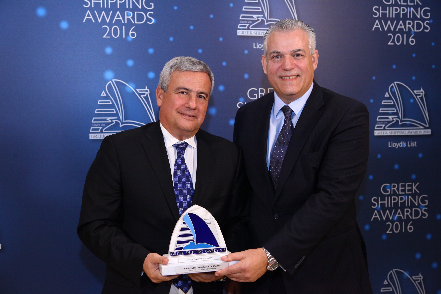 Mr. Leonidas Demetriades-Eugenides of the Eugenides Foundation accepting the Award for Achievement in Education or Training from Mr. Dimitris Heliotis of sponsor Target Marine Group.