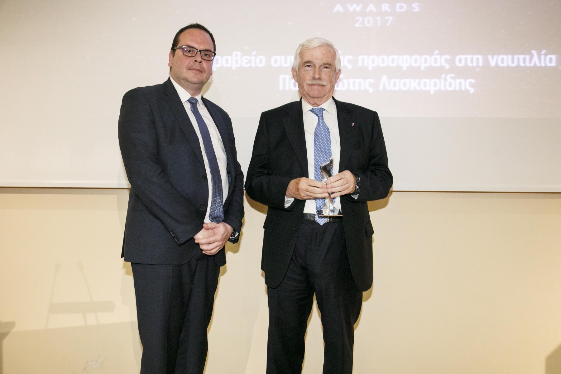 Ο κ. Παναγιώτης Λασκαρίδης, παραλαμβάνει το βραβείο από τον κ. Γιάννη Ξενακούδη, Seafarers' Documentation Officer του νηολογίου των Νήσων Marshall